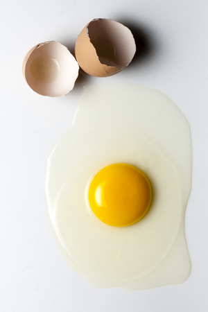 Top view splattered broken egg and egg shellの写真素材