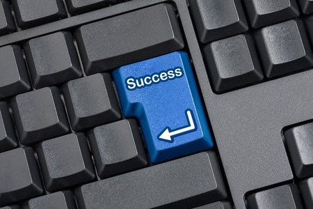 computer keyboard with Enter key replaced with blue Success Keyの写真素材