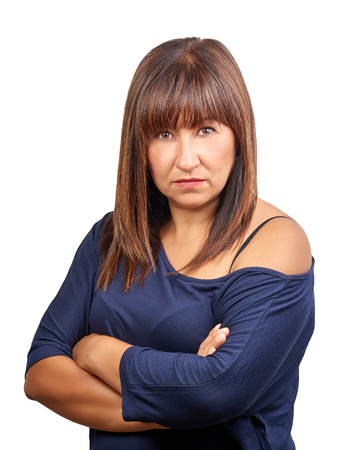 Brunette woman angry with crossed arms isolated on whiteの写真素材