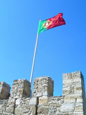 Waving Portuguese Flag on Saint George Castle in Lisbon, Portugalのeditorial素材