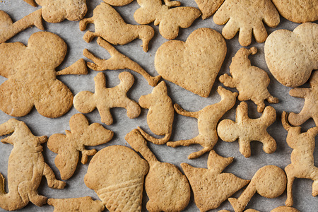 Top view of home made biscuits on oven paper on baking tray