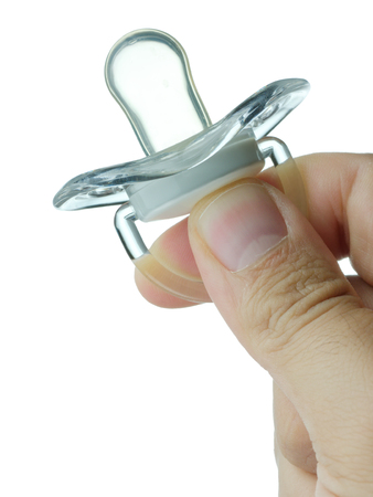Hand holding pacifier isolatedの写真素材