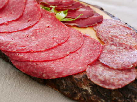 Salami slices on the tableの写真素材