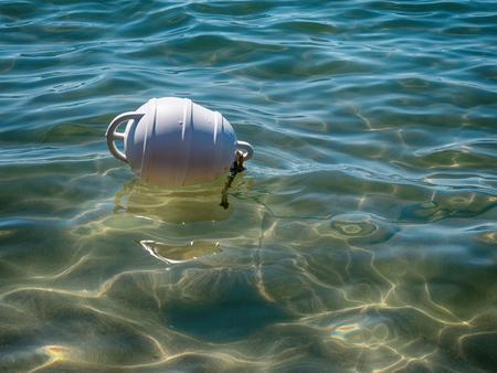 White buoy floating on the sea