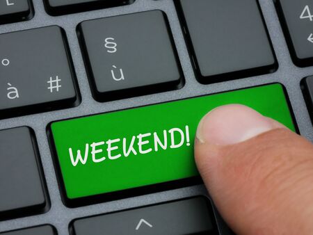 Closeup finger typing on weekend key on computer keyboardの写真素材