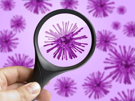 Hand holding magnifying glass focusing on virus bacterium cellの写真素材