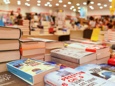 Milan, Italy - 2019 August: Piles of books on sale at modern bookshopのeditorial素材
