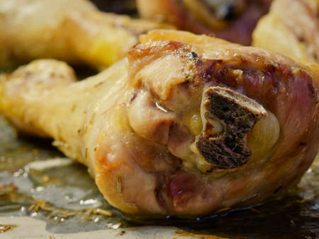 Closeup roasted chicken thigh on oven tray