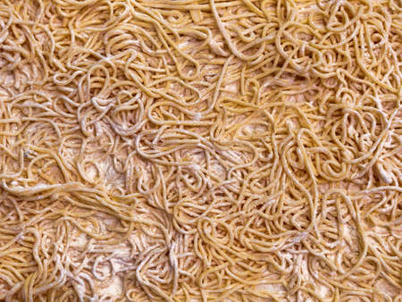 Italian Homemade uncooked pasta on wooden board top view