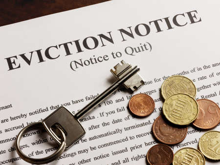 Eviction note coins and apartment keyの写真素材