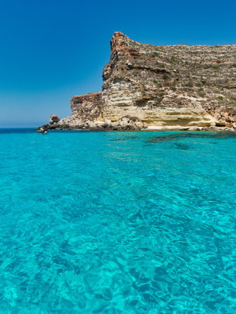 blue sea and blue sky rocks lampedusa rabbits beach sicily italy meditherranean seaの写真素材