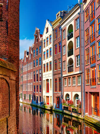 Amsterdam typical dutch houses reflected in the canal Holland, Netherlands.の写真素材