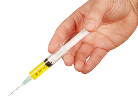 Close up or closeup Human male Hand of doctor or veterinary holding syringe going to inject vaccine or medicine or drug isolated on whiteの写真素材
