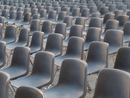 Vavant or empty plasti gray chairs outdoor arranged for event or performance