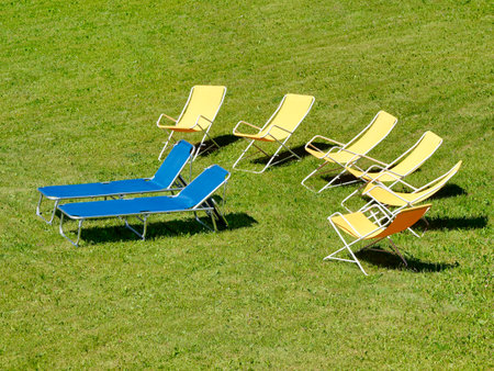 vacant chairs on the grass in summer for relax momentsの写真素材
