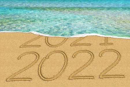 Happy New Year 2022 and leaving year of 2021 concept text on the sea beachの写真素材