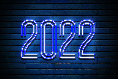 2022 glowing blue neon text on brick wallの写真素材