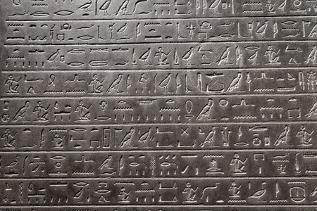 Ancient Egyptian stone with hieroglyphs in low graving