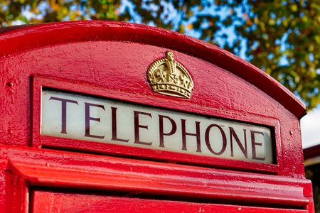 Close-Up view of Telephone sign on Red Telephone Box in London,UKの写真素材