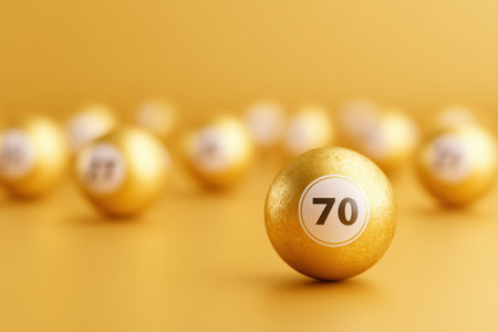 A close-up view of golden lottery balls with numbers on a vibrant yellow background. This image captures the excitement and anticipation associated with lottery games. ai generated.の素材