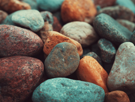 A close-up view of assorted pebble stones showcasing a variety of colors and textures. These natural stones can be used for landscaping, decoration, or as a unique element in art projects. ai generated.の素材