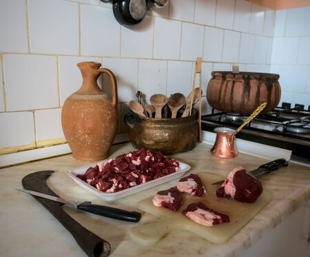 Shot of authentic kitchen with historical kitchen tools on background with liver meat on chopping...