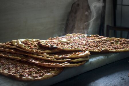 Close up Delicious spicy and steamy stack of traditional Turkish pitas fresh out of oven put on marble ground at Ramadan monthの写真素材