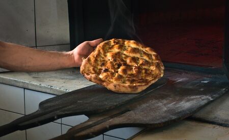 Beautiful and delicious and steamy traditional ramadan bread of turkish cuisine fresh out of the oven in bakeryの写真素材