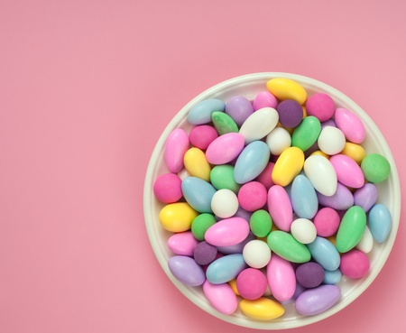 Jordan Almond Candies in a Dish on Pink Backgroundの写真素材