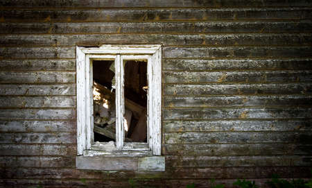Old wooden wall with a windowの写真素材