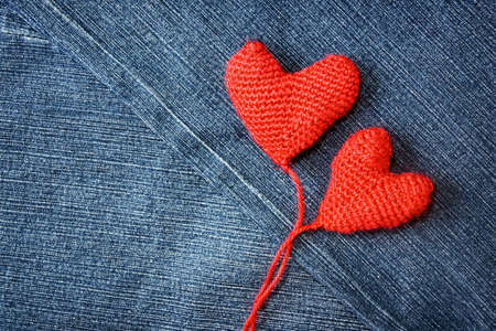 Knitted heart on blue jeans texture の写真素材