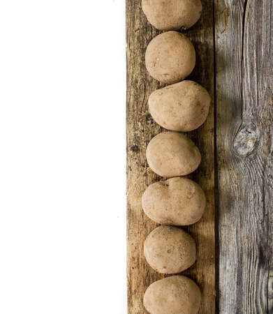 Potatoes on wooden boardの写真素材