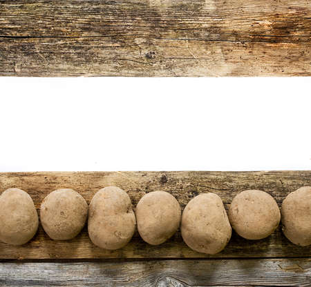 Potatoes on wooden boardの写真素材