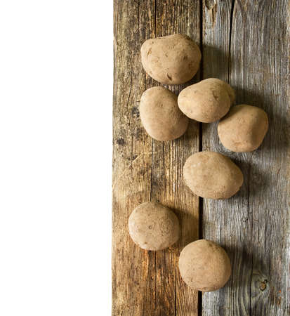 Potatoes on wooden boardの写真素材