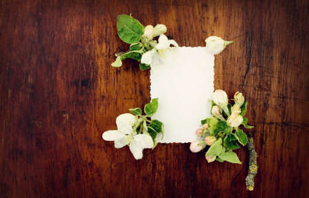 Paper with flowers on wooden surfaceの写真素材