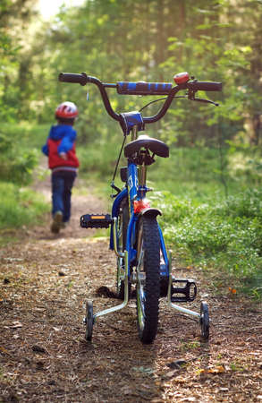 Boy on bike in the forestの写真素材