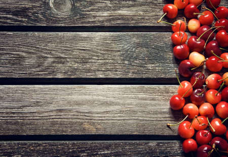 Cherry on old wooden boardの写真素材