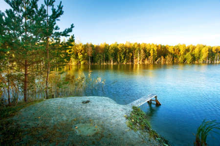 Small bridge on a lake in autumnの写真素材