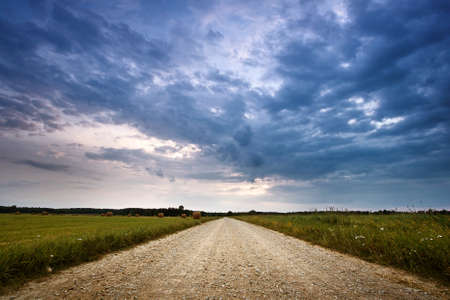 Evening country road with dramatic skyの写真素材