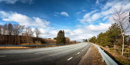 black asphalt road on sunny spring dayの写真素材