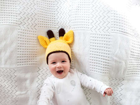 little boy lying on soft white blanketの写真素材