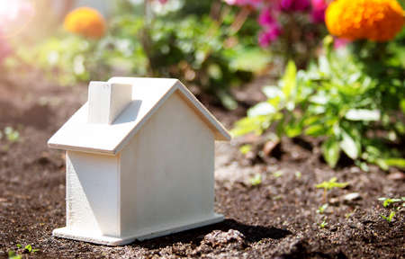 wooden house toy on the grass in gardenの写真素材
