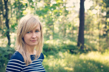 young woman in the forest on sunny summer dayの写真素材