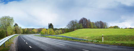 wet road panorama with beautiful clouds in the skyの写真素材