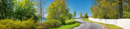 Car on asphalt road in beautiful spring day at countrysideの写真素材