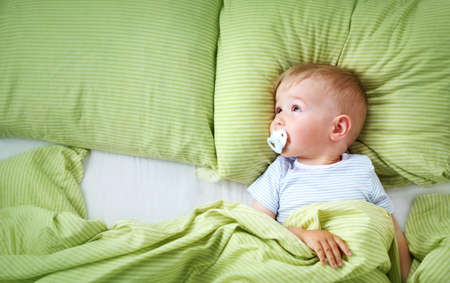 One year old baby lying on blue towel with starsの写真素材