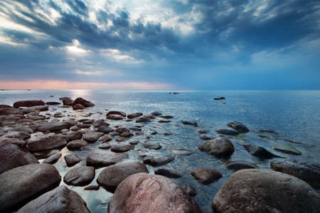 Rocky shores at the sea in sunset light. Lahemaa natural park coastal landscape with beautiful skyの写真素材