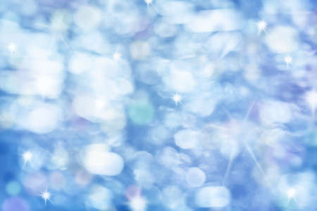 Blurred blue christmas background with beautiful bokehの写真素材