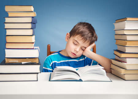seven years old child reading a bookの写真素材