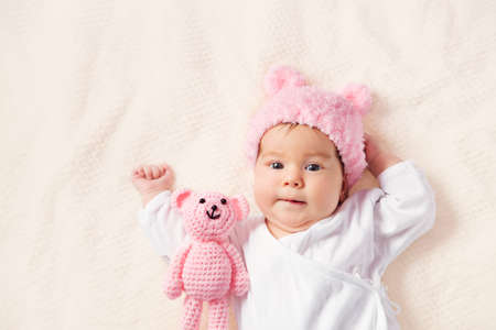 Cute newborn baby girl lying in the bedの写真素材
